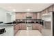 Well-equipped kitchen with stainless steel appliances, tile backsplash, and ample cabinet space at 3038 Golden Rock Dr, Orlando, FL 32818
