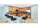 Bright kitchen features breakfast bar with seating, wood cabinets, stainless steel appliances, and tile backsplash at 3038 Golden Rock Dr, Orlando, FL 32818