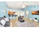 Open-concept living area with kitchen bar, comfortable seating, and tile flooring at 3038 Golden Rock Dr, Orlando, FL 32818