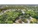 Aerial view of community with lake and wooded areas at 316 Dornoch Ct, Winter Springs, FL 32708