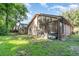 View of backyard and sunroom from grassy area at 316 Dornoch Ct, Winter Springs, FL 32708