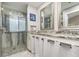 Bathroom featuring tiled standing shower, dual sinks and granite countertops at 316 Dornoch Ct, Winter Springs, FL 32708