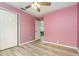 Pink bedroom with laminate flooring, ceiling fan and closet at 316 Dornoch Ct, Winter Springs, FL 32708