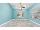 Light-filled bedroom featuring blue walls, tile flooring, white trim, and large windows at 316 Dornoch Ct, Winter Springs, FL 32708