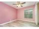 Pink bedroom with wood laminate flooring, ceiling fan and closet at 316 Dornoch Ct, Winter Springs, FL 32708