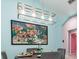 Bright dining area boasts stylish light fixture and a colorful painting accenting the room at 316 Dornoch Ct, Winter Springs, FL 32708