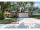 Charming brick home featuring a two-car garage, manicured lawn, and a welcoming front entrance at 316 Dornoch Ct, Winter Springs, FL 32708