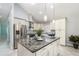 Modern kitchen featuring a large island, stainless steel appliances, and pendant lighting at 316 Dornoch Ct, Winter Springs, FL 32708
