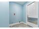 Cozy laundry room with pale blue walls, tile floor, and exterior door at 316 Dornoch Ct, Winter Springs, FL 32708