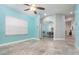 Open-concept living room with blue accent wall, tile floors, ceiling fan, and dining area at 316 Dornoch Ct, Winter Springs, FL 32708