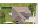 Overhead shot of a home highlighting its roof, surrounding greenery, patio, and yard at 3551 Statham Dr, Apopka, FL 32712