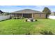 This home's large backyard includes a stone patio with a grill, perfect for outdoor entertaining at 3551 Statham Dr, Apopka, FL 32712