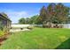 Spacious backyard features lush green grass, a white fence, and mature trees for privacy at 3551 Statham Dr, Apopka, FL 32712