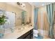 Well-lit bathroom featuring a vanity with a large mirror and a shower-tub combination at 3551 Statham Dr, Apopka, FL 32712
