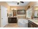 Bright bathroom boasting a soaking tub, double vanity, and decorative fixtures at 3551 Statham Dr, Apopka, FL 32712