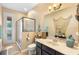 Cozy bathroom with a walk-in shower and a vanity featuring elegant fixtures and nautical-themed decor at 3551 Statham Dr, Apopka, FL 32712