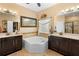 Bathroom with a soaking tub, double sinks, and a tiled shower enclosure at 3551 Statham Dr, Apopka, FL 32712