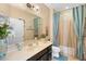 Bright bathroom featuring a vanity with a mirror and shower with curtains at 3551 Statham Dr, Apopka, FL 32712