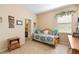 Neutral bedroom features a daybed, natural light, and a charming cozy atmosphere with a view to an ensuite bathroom at 3551 Statham Dr, Apopka, FL 32712