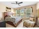 Cozy bedroom featuring a ceiling fan, comfortable furnishings, and natural light at 3551 Statham Dr, Apopka, FL 32712