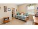 Bright bedroom featuring a daybed with decorative pillows, a dresser, and natural light at 3551 Statham Dr, Apopka, FL 32712