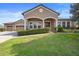 Attractive home featuring an attached three car garage and manicured green lawn at 3551 Statham Dr, Apopka, FL 32712