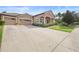 Charming home boasts a well-manicured lawn and a spacious driveway leading to a three-car garage at 3551 Statham Dr, Apopka, FL 32712