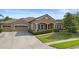 Attractive home with a well-kept lawn, a three-car garage, and a welcoming front porch at 3551 Statham Dr, Apopka, FL 32712