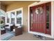 Inviting front porch with a cozy seating area and decorative wreath on the front door at 3551 Statham Dr, Apopka, FL 32712
