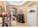 Hallway with archway, hard surface floors, large decorative clock, and a white door to the laundry room at 3551 Statham Dr, Apopka, FL 32712