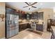 Modern kitchen with dark cabinets and stainless steel refrigerator and microwave at 3551 Statham Dr, Apopka, FL 32712