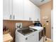 Convenient laundry room with white cabinets and modern appliances at 3551 Statham Dr, Apopka, FL 32712