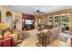 Bright living room featuring a comfortable sofa, ceiling fan, and glass doors at 3551 Statham Dr, Apopka, FL 32712