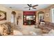 Cozy living room with a fireplace, media center, and comfortable seating at 3551 Statham Dr, Apopka, FL 32712