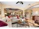 Cozy living room featuring an open floor plan with beige textured walls and neutral-toned furnishings at 3551 Statham Dr, Apopka, FL 32712