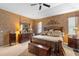 Serene main bedroom featuring a tray ceiling and ample natural light at 3551 Statham Dr, Apopka, FL 32712