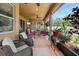 A covered patio offering a comfortable seating area and beautiful views of the outdoors at 3551 Statham Dr, Apopka, FL 32712