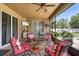 Relaxing covered patio with seating around a fire pit and a view of the lush backyard at 3551 Statham Dr, Apopka, FL 32712