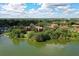 Aerial view of residences nestled among lush trees near a tranquil lake, promoting peace at 380 Lake Ontario Ct # 304, Altamonte Springs, FL 32701