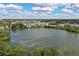 Scenic aerial view of lake, community buildings, and lush landscapes, offering a serene retreat at 380 Lake Ontario Ct # 304, Altamonte Springs, FL 32701