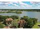 Beautiful aerial view of the lake, community buildings with balconies, and verdant trees at 380 Lake Ontario Ct # 304, Altamonte Springs, FL 32701