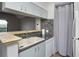 Open kitchen design features a breakfast bar, sink, dishwasher and neutral-toned cabinetry at 380 Lake Ontario Ct # 304, Altamonte Springs, FL 32701