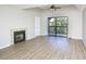 Bright living room featuring wood floors, a fireplace, and sliding door to a balcony at 380 Lake Ontario Ct # 304, Altamonte Springs, FL 32701