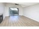 Bright living room featuring wood floors, a fireplace, and sliding door to a balcony at 380 Lake Ontario Ct # 304, Altamonte Springs, FL 32701