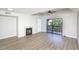 Bright living room featuring wood floors, a fireplace, and sliding door to a balcony at 380 Lake Ontario Ct # 304, Altamonte Springs, FL 32701