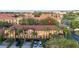 Aerial view of the townhome complex, showing the roof, landscaping, and parking spaces in the area at 412 Verona Ave, Davenport, FL 33897