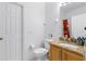 Cozy bathroom featuring a granite countertop, toilet, and white textured walls at 412 Verona Ave, Davenport, FL 33897