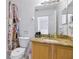 Bathroom with a vanity, granite counters and a shower with bright lighting at 412 Verona Ave, Davenport, FL 33897