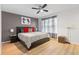 Bedroom featuring a cozy bed with stylish decor and a ceiling fan for added comfort at 412 Verona Ave, Davenport, FL 33897