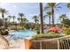 Resort-style pool surrounded by palm trees, lounge chairs, and lush landscaping at 412 Verona Ave, Davenport, FL 33897
